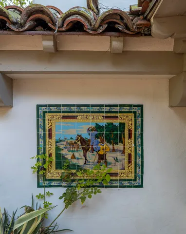 a front view of a house with lake and trees around