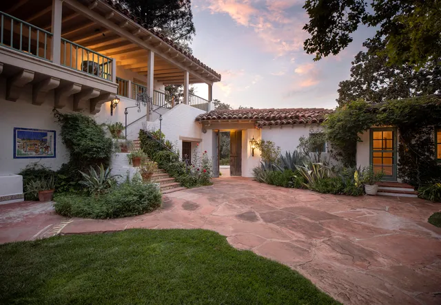 a view of a patio with a table and chairs and couches