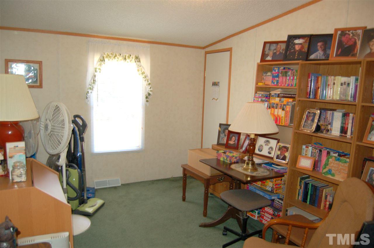 7509 Russell Road Durham, NC 27712 - Photo 14 of 25 a reading room with furniture book shelf and a window