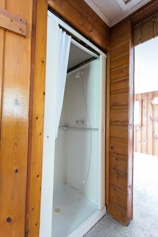 an aerial view of a house with a garden and lake view