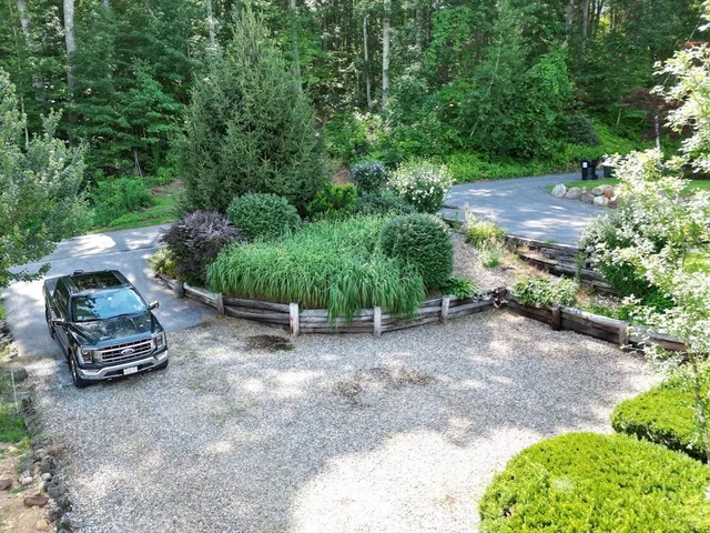 a view of house with swimming pool and outdoor seating