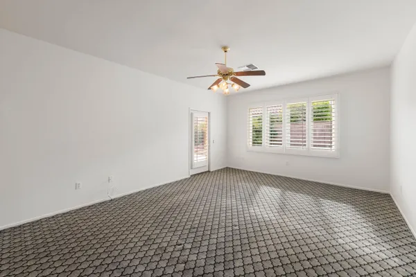 a kitchen with granite countertop white cabinets and black appliances