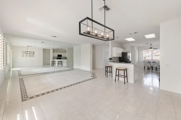 a kitchen with granite countertop white cabinets sink and stainless steel appliances