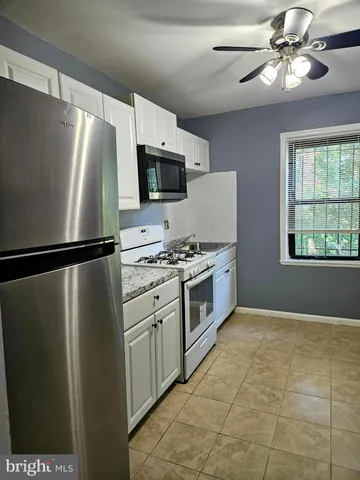 a kitchen with stainless steel appliances a refrigerator sink and microwave