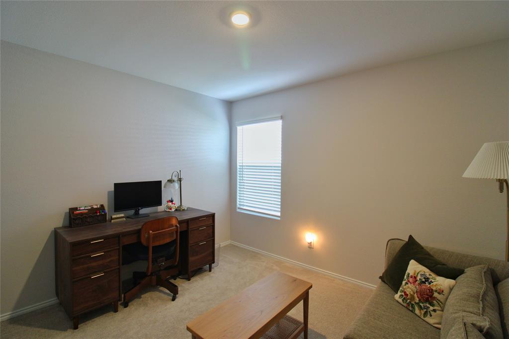 11740 Marcellus Way Rhome, TX 76078 - Photo 19 of 33 a room with furniture and a flat screen tv
