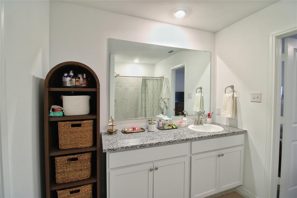 11740 Marcellus Way Rhome, TX 76078 - Photo 22 of 33 a bathroom with a sink a vanity and a mirror