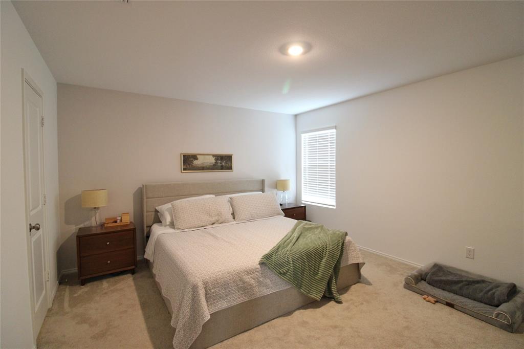 11740 Marcellus Way Rhome, TX 76078 - Photo 25 of 33 a bedroom with a bed and a tv