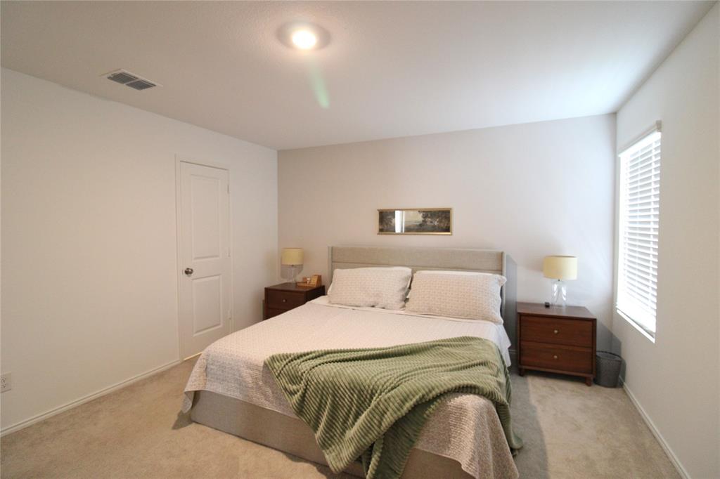 11740 Marcellus Way Rhome, TX 76078 - Photo 26 of 33 a bedroom with a bed and a window