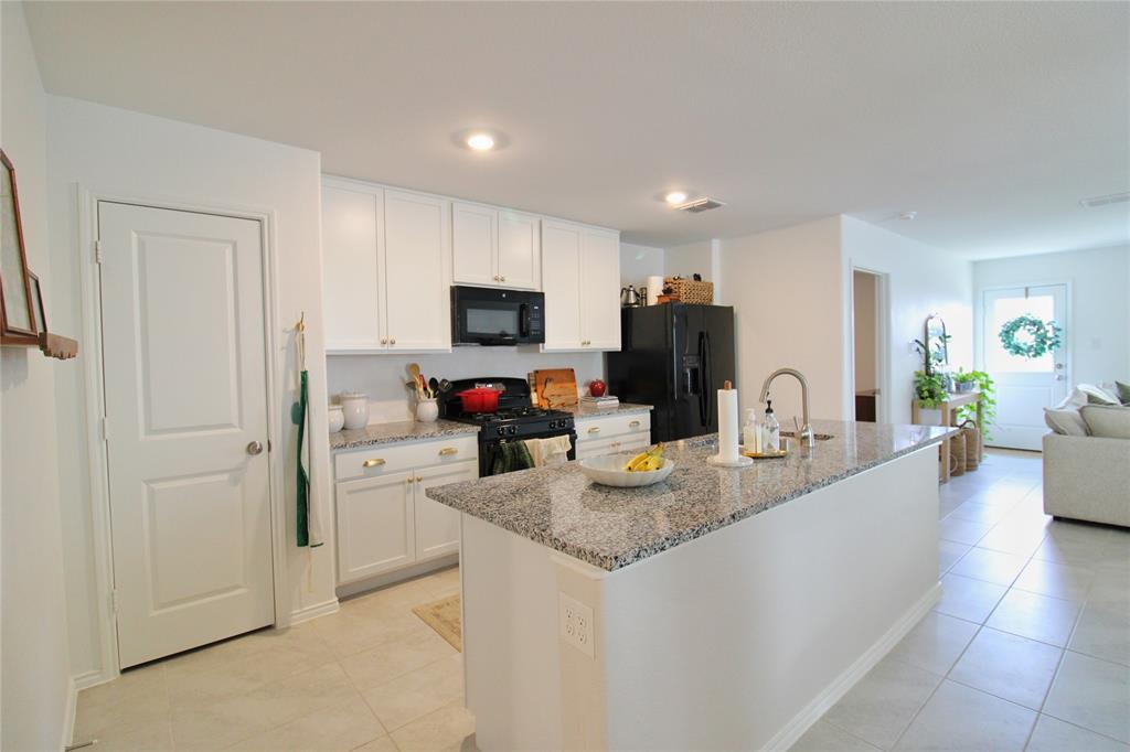11740 Marcellus Way Rhome, TX 76078 - Photo 33 of 33 a kitchen with sink a microwave and cabinets