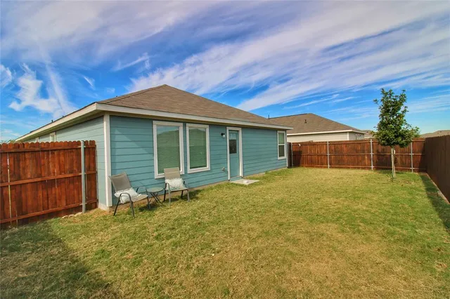 a view of backyard with seating area
