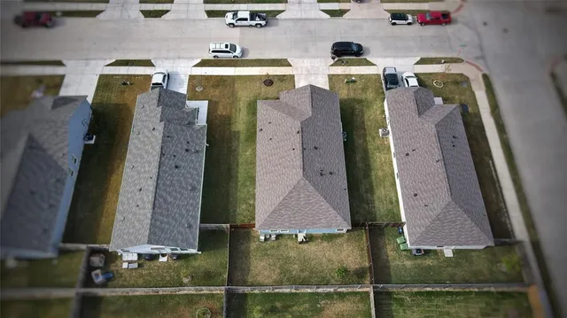 an aerial view of residential houses with outdoor space