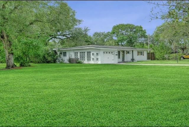 1571 Riverland Road Fort Lauderdale, FL 33312 - Photo 25 of 25 a front view of a house with a garden