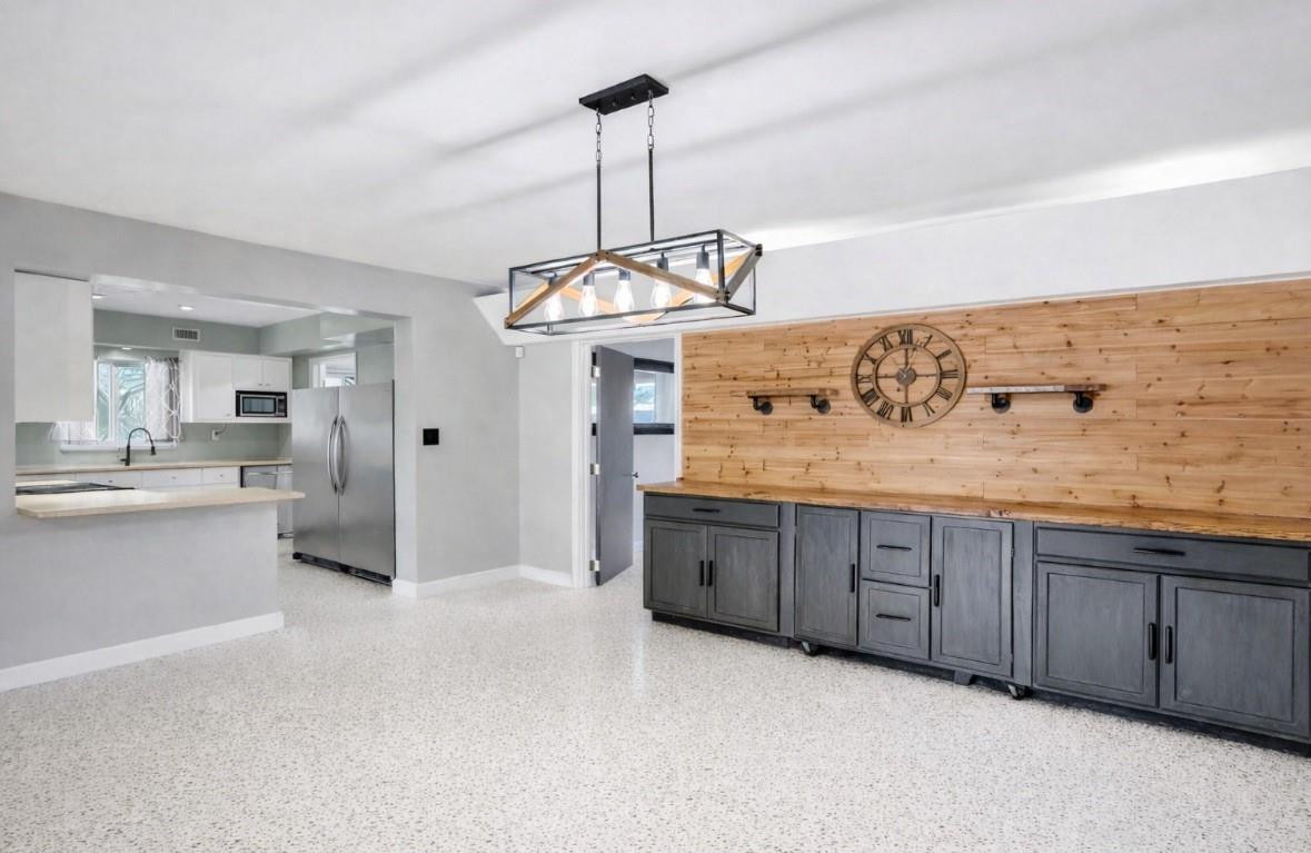 1571 Riverland Road Fort Lauderdale, FL 33312 - Photo 5 of 25 a kitchen with a refrigerator and a sink