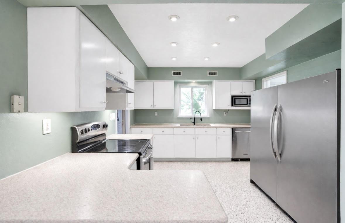 1571 Riverland Road Fort Lauderdale, FL 33312 - Photo 6 of 25 a kitchen with a refrigerator sink and cabinets