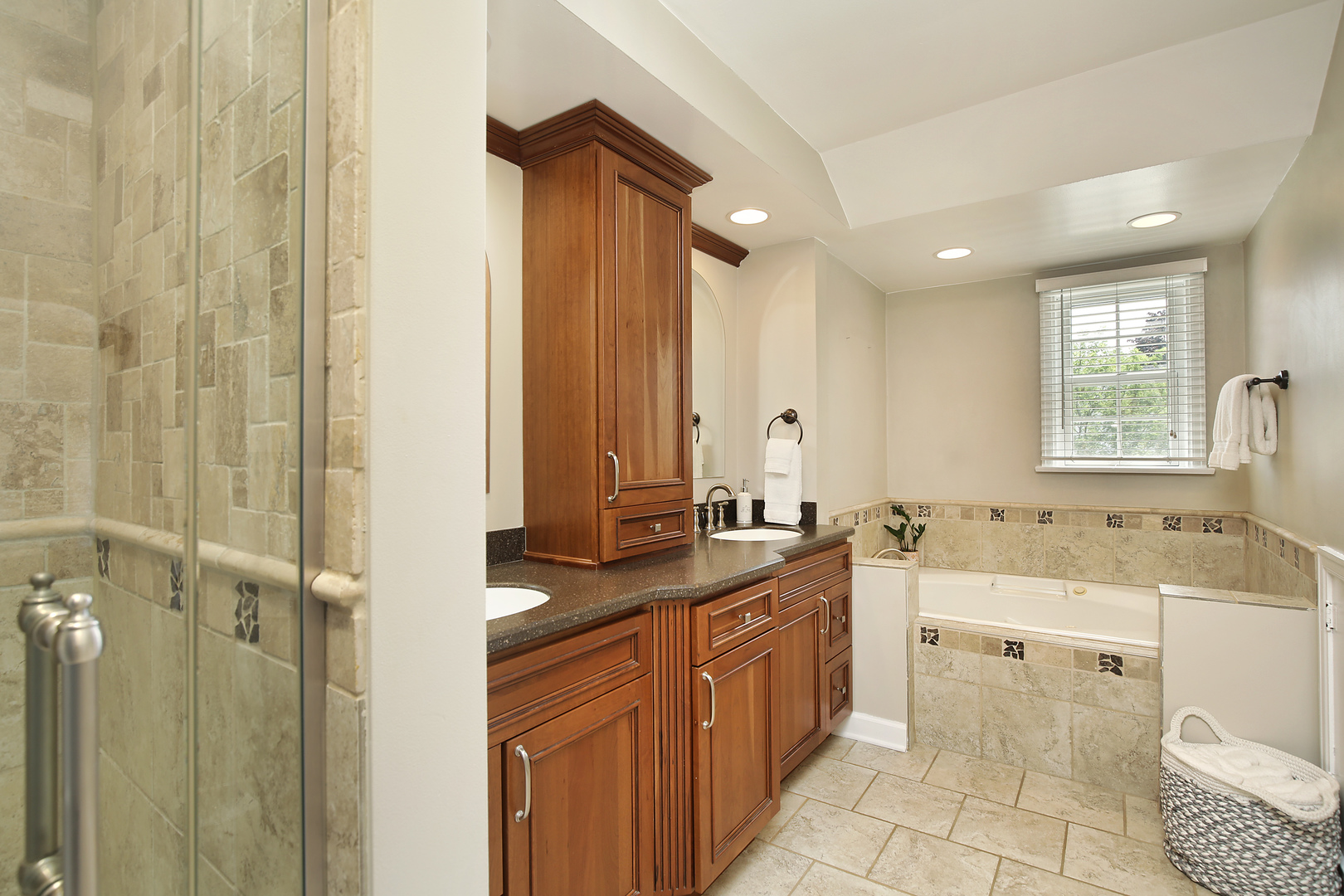 2224 Crabtree Lane Northbrook, IL 60062 - Photo 14 of 34 a bathroom with a granite countertop sink toilet mirror and a bathtub