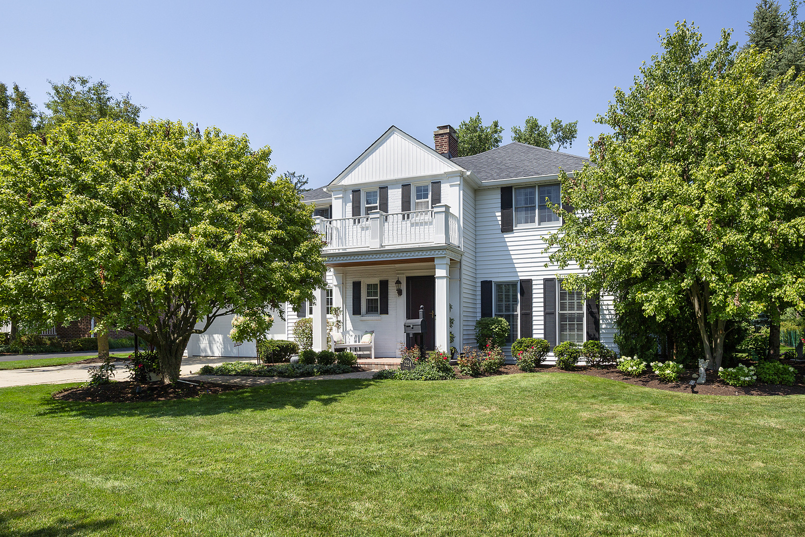 2224 Crabtree Lane Northbrook, IL 60062 - Photo 28 of 34 a front view of a house with a garden and trees