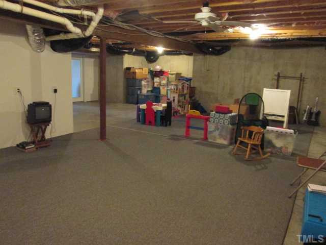 8120 Standing Stone Court Raleigh, NC 27613 - Photo 23 of 25 This full basement features an inside entrance, as well as outside entrance too. Use space for added storage, perhaps a workout room or home workshop, as you will see in other photo! Other