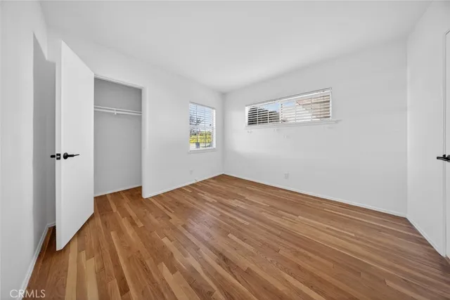 a view of a closet area with wooden floor