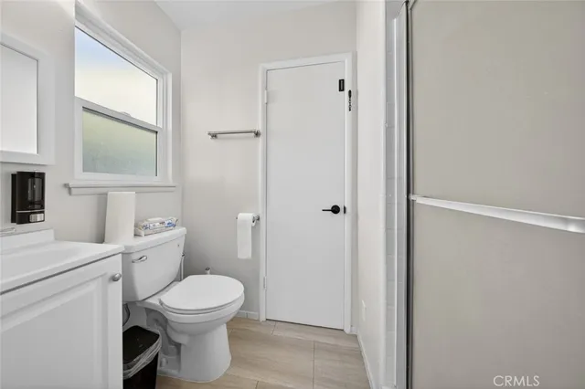 a backyard of a house with seating space and a tree