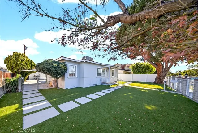 a hallway with wooden floor next to a white door