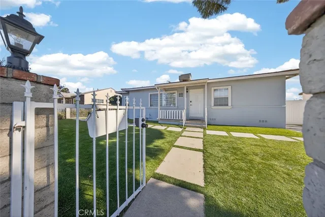 a view of a backyard with table and chairs and potted plants