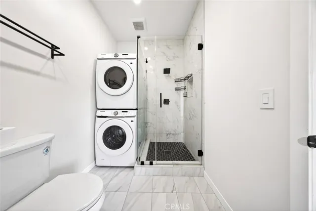 a view of a kitchen with a sink and a refrigerator