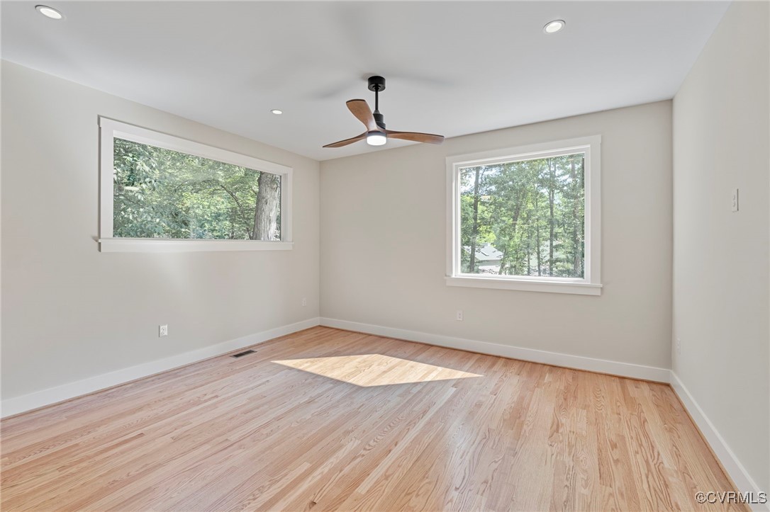 34 Turkeysag Trail Palmyra, VA 22963 - Photo 4 of 44 an empty room with wooden floor chandelier fan and windows