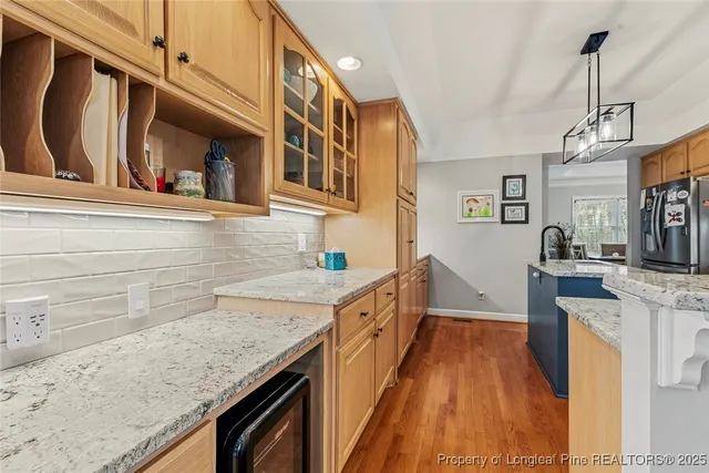 a kitchen with granite countertop a sink stove and cabinets