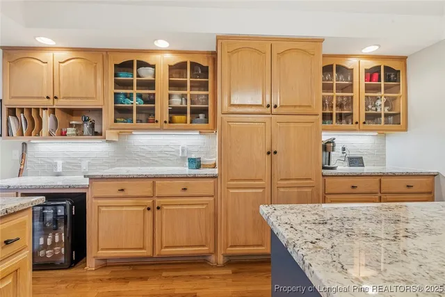 a view of kitchen with granite countertop wooden cabinets and a sink