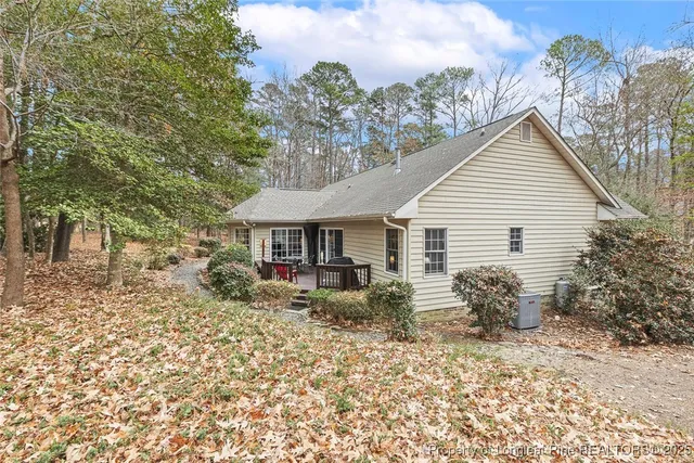 a backyard of a house with table and chairs