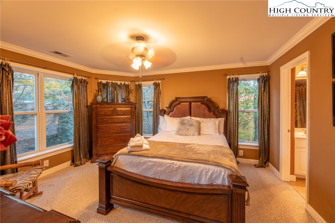 309 Pinnacle Ridge Road Beech Mountain, NC 28604 - Photo 18 of 45 a bedroom with a bed and wooden floor