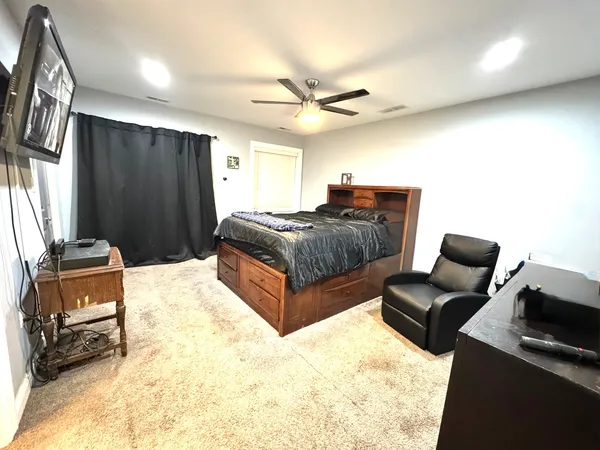 a spacious bedroom with a bed and furniture