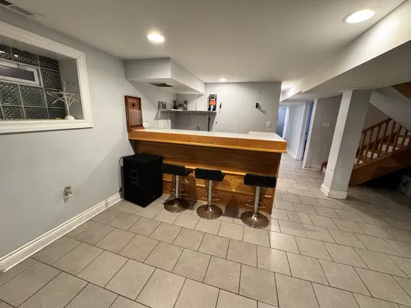 a room with gym equipment and a rug