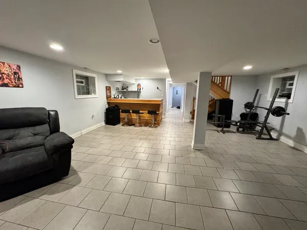 a living room with furniture and a dining table with kitchen view