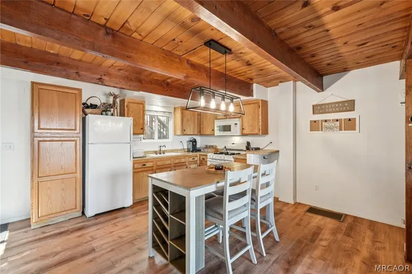 a kitchen with a refrigerator and a table