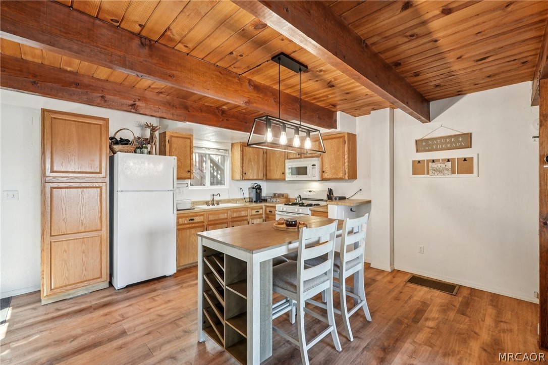 2409 Spring Oak Drive Running Springs, CA 92382 - Photo 11 of 24 a kitchen with a refrigerator and a table