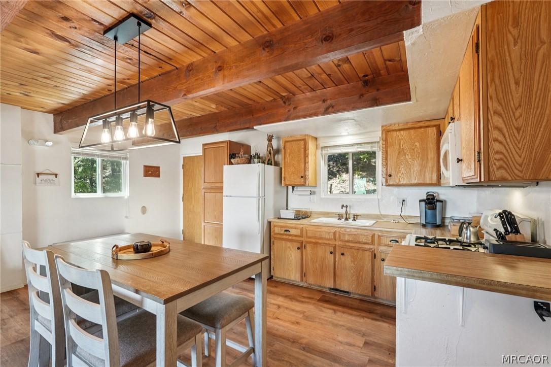 2409 Spring Oak Drive Running Springs, CA 92382 - Photo 12 of 24 a kitchen with stainless steel appliances granite countertop a sink a stove and chairs