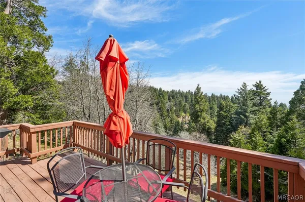 a view of balcony with wooden floor and outdoor seating