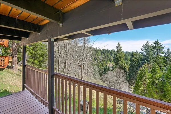 a view of a balcony with wooden floor