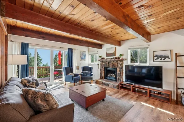 a living room with fireplace furniture and a flat screen tv