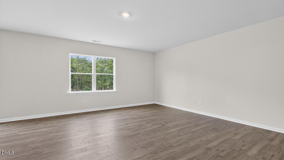 189 Calebs Cor Place Spring Lake, NC 28390 - Photo 13 of 42 an empty room with wooden floor and windows
