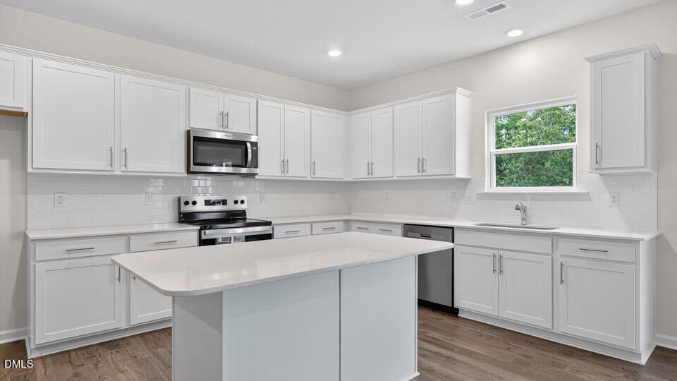 189 Calebs Cor Place Spring Lake, NC 28390 - Photo 15 of 42 a kitchen with appliances a sink a window and cabinets