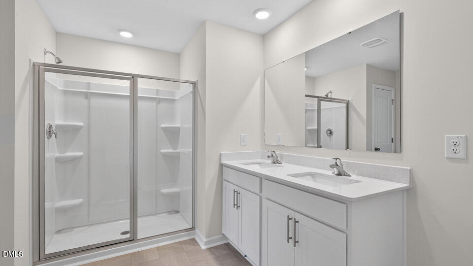 189 Calebs Cor Place Spring Lake, NC 28390 - Photo 28 of 42 a bathroom with a shower sink and mirror