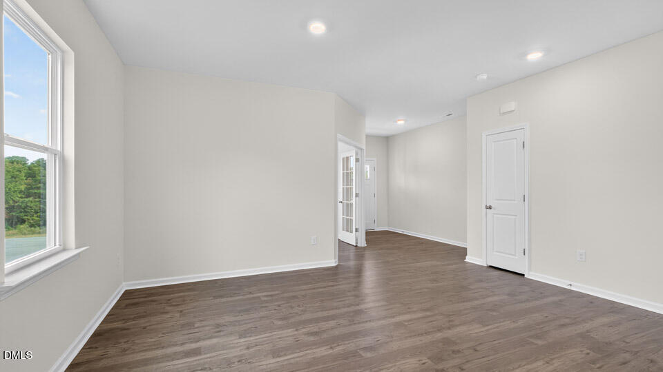189 Calebs Cor Place Spring Lake, NC 28390 - Photo 7 of 42 a view of an empty room with wooden floor and a window