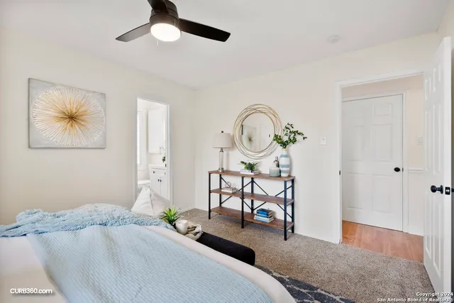 a bedroom with bed and a chandelier
