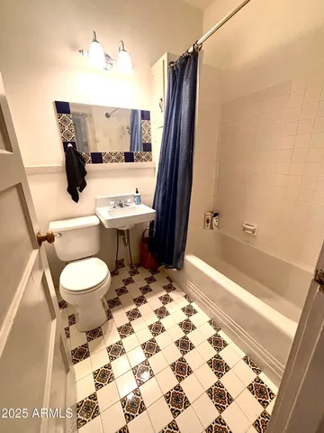 a living room with a bed furniture and a window