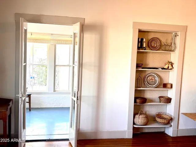 a view of a workspace with furniture and a window