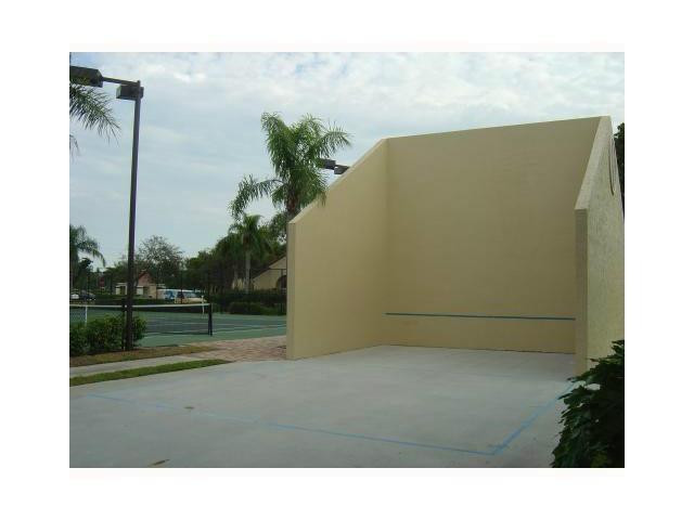 621 Lyons Road, Unit 9101 Coconut Creek, FL 33063 - Photo 17 of 21 a living room with a couch