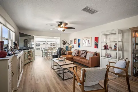 a living room with furniture and a kitchen view