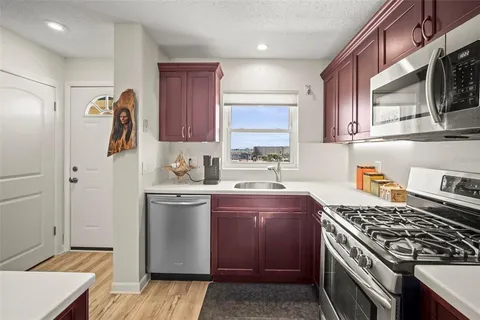 a kitchen with stainless steel appliances granite countertop a stove and a sink
